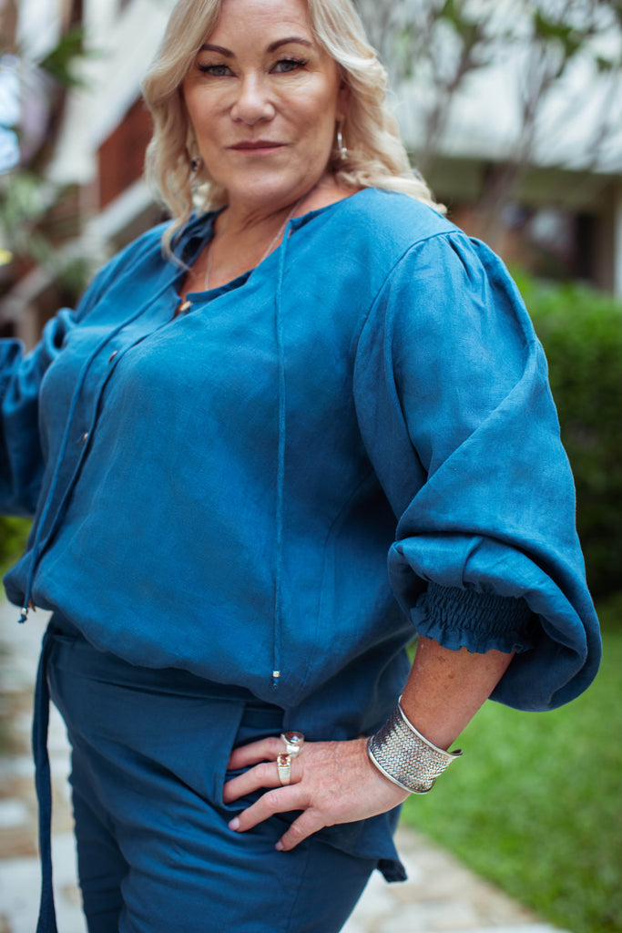 Taleeta - Blue Cotton Pants - Puff Sleeve Shirt Blue - Facing Front Left - Arm Stretched - Medium Closeup Shot