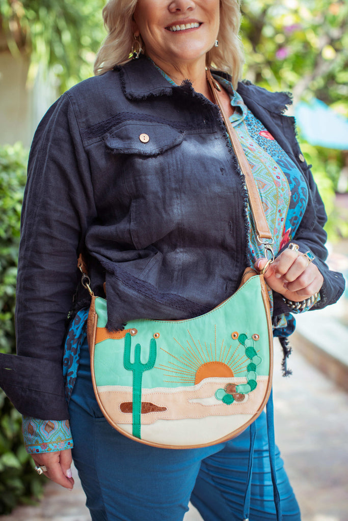 Taleeta - Indigo Jacket - Blue Hibiscus Jungle Blouse & Blue Cotton Pants & Leather Bag - Facing Front Right - Midway Closeup Shot