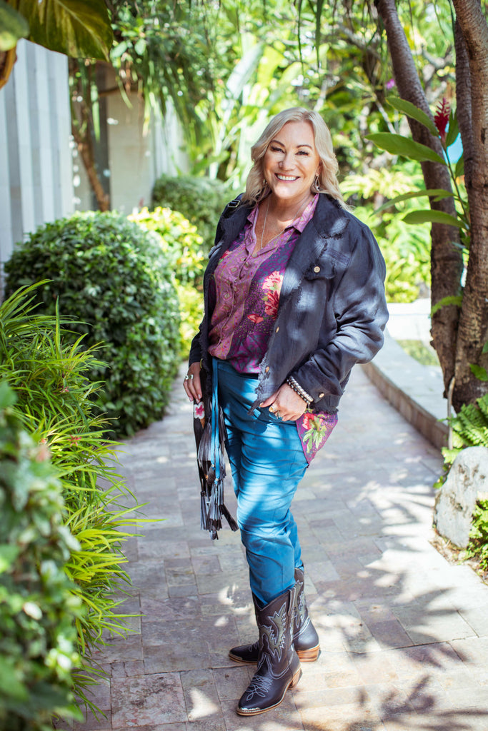 Taleeta - Indigo Jacket - Purple Hibiscus Jungle Blouse & Blue Cotton Pants & Leather Bag - Facing Front Left - Fullshot
