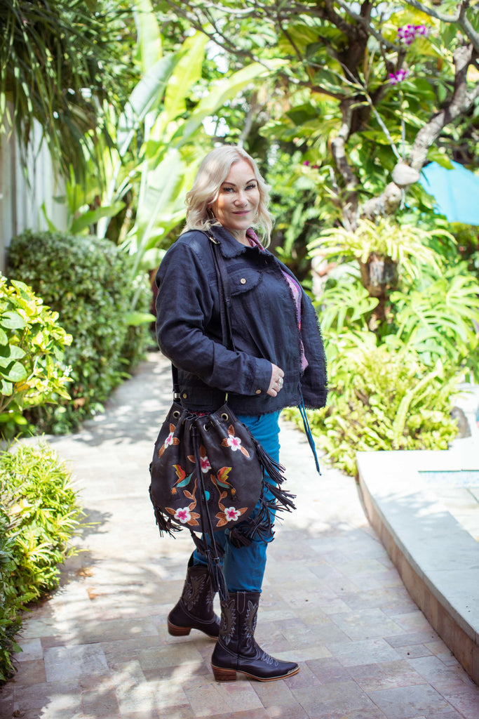 Taleeta - Indigo Jacket - Purple Hibiscus Jungle Blouse & Blue Cotton Pants & Leather Bag - Facing Right Side - Fullshot