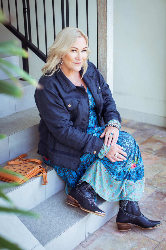 Taleeta - Indigo Jacket - Blue Hibiscus Jungle Dress &  Leather Bag - Facing Front Right - Sitting - Fullshot