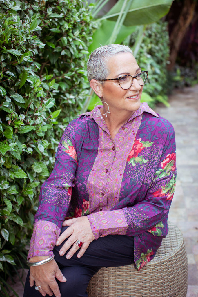 Taleeta - Purple Hibiscus Jungle Blouse - Indigo Cotton Pants - Facing Front Right - Sitting - Medium Fullshot