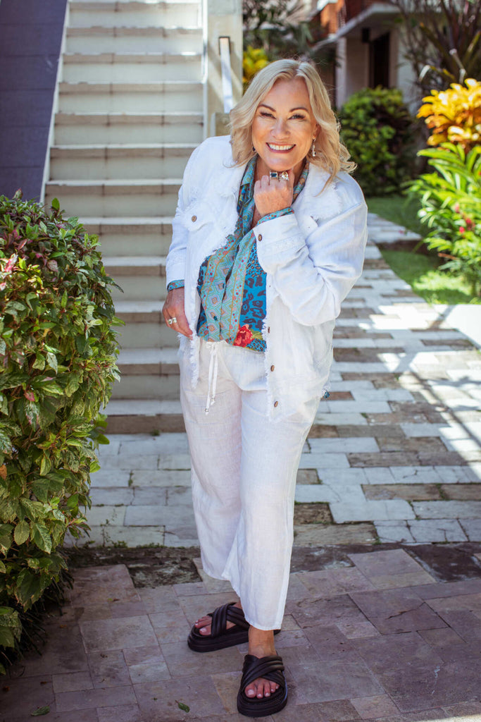 Taleeta - White Jacket - Blue Hibiscus Jungle Blouse - Facing Front Right - Fist On Chin Pose - Fullshot