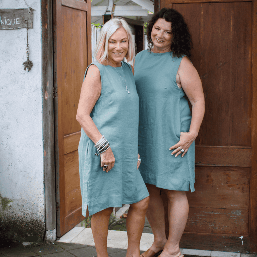 Two women wearing sage green linen dress